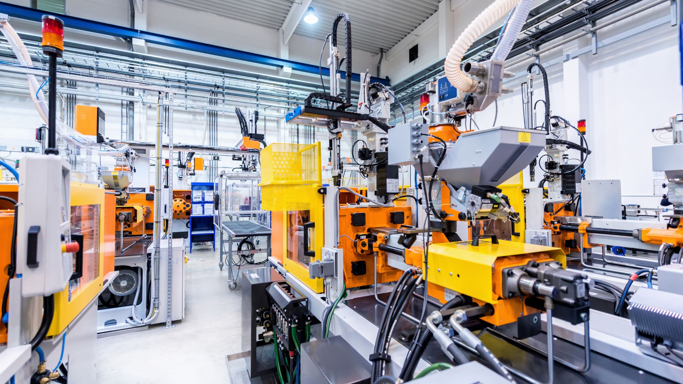 Automated injection moulding machine cell on a production floor