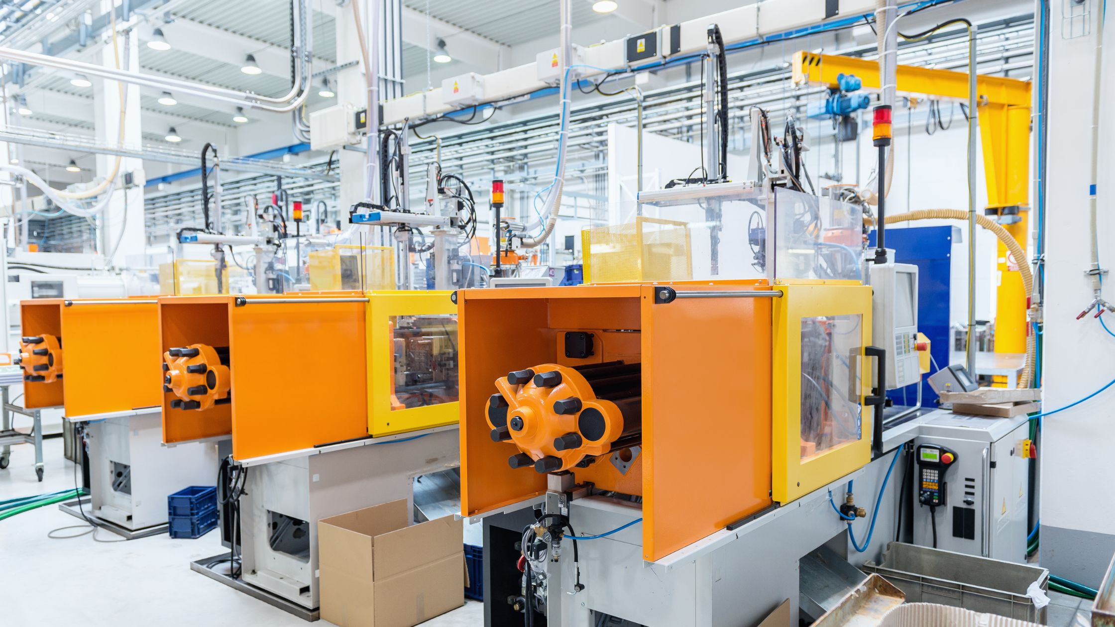 Row of injection moulding machines in modern production facility